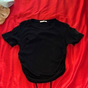 Bought it from LEA and it’s a black crop top shirt open from the back